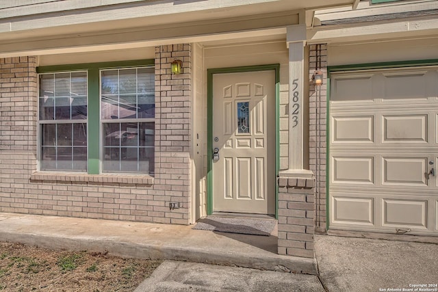 5823 Barton Holw, San Antonio, TX 78249 - entrance to property with brick siding, a garage, and a porch