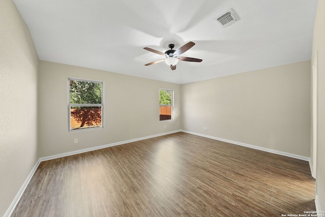 spare room with ceiling fan and dark hardwood / wood-style flooring