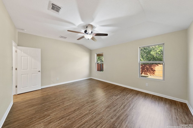 unfurnished room with vaulted ceiling, ceiling fan, and dark wood-type flooring