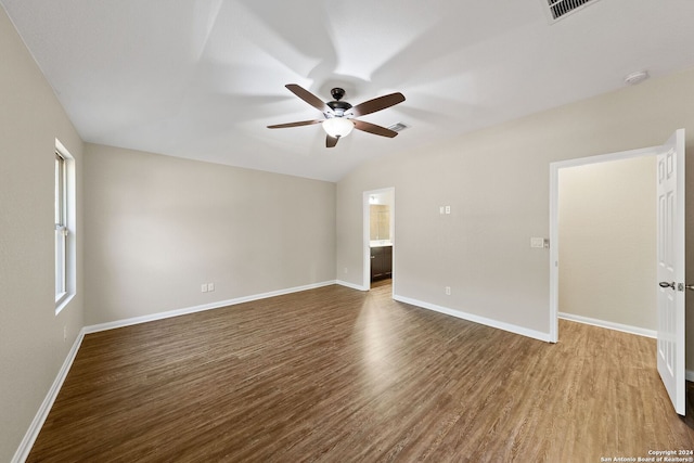 empty room featuring wood-type flooring, vaulted ceiling, and ceiling fan