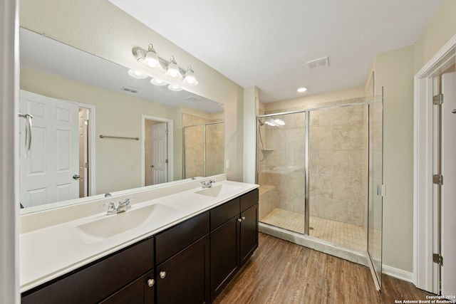 bathroom featuring an enclosed shower, vanity, and hardwood / wood-style flooring