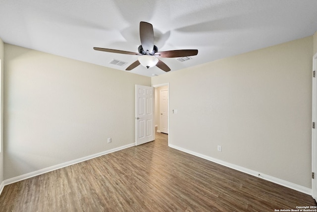 empty room with ceiling fan and hardwood / wood-style floors