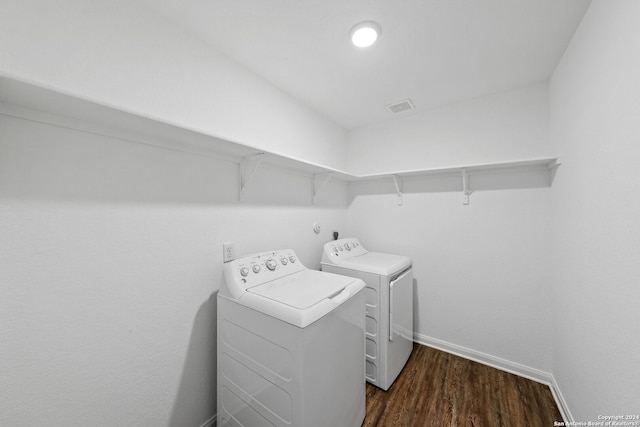 washroom with washer and clothes dryer and dark hardwood / wood-style flooring