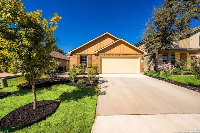 view of front of home with a front yard and a garage