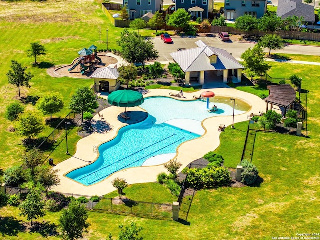 view of pool featuring a playground, a patio area, and a yard