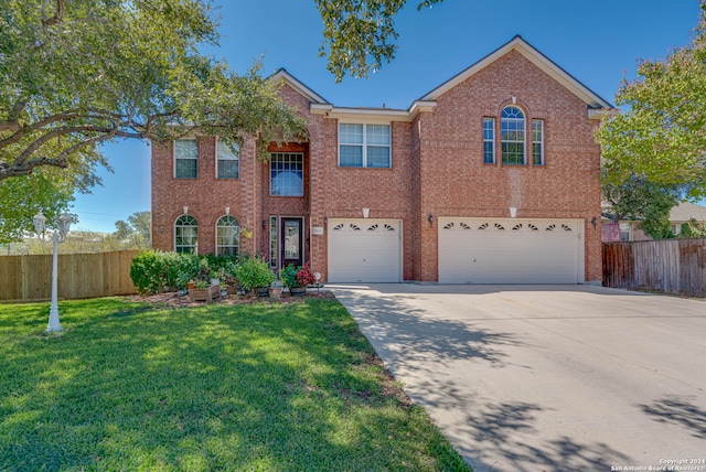 view of front of house featuring a front yard and a garage