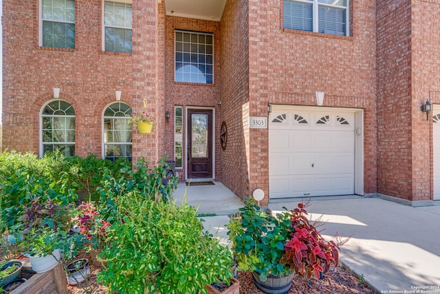 3303 Cambria Way, San Antonio, TX 78251 - property entrance with driveway, brick siding, and an attached garage