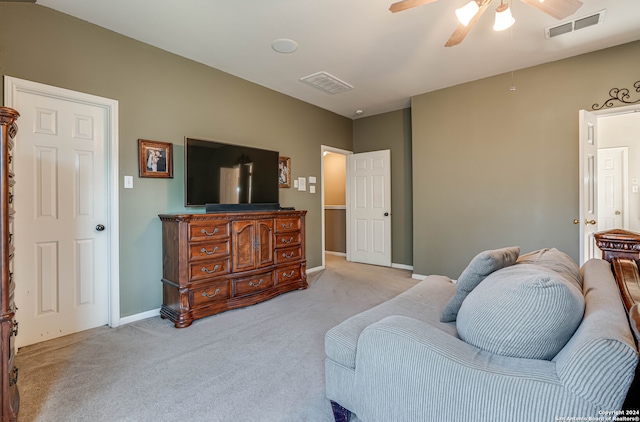 sitting room with ceiling fan and light colored carpet