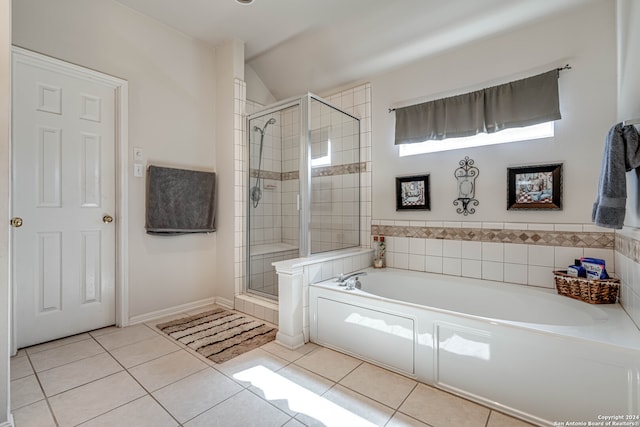 bathroom with independent shower and bath, tile patterned flooring, and lofted ceiling