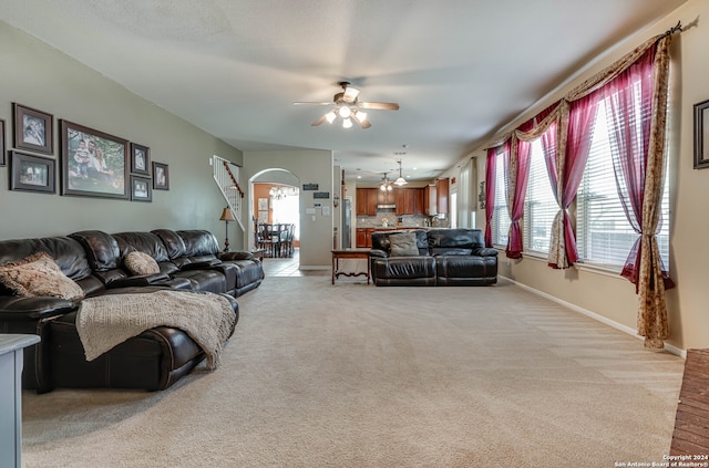 living room featuring ceiling fan and light colored carpet