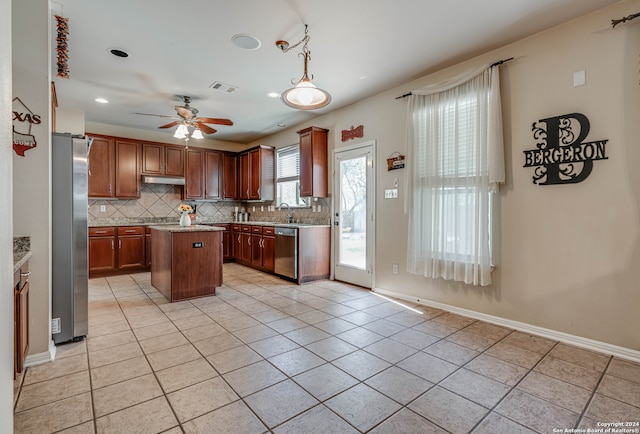 kitchen with tasteful backsplash, light tile patterned floors, stainless steel appliances, a center island, and ceiling fan