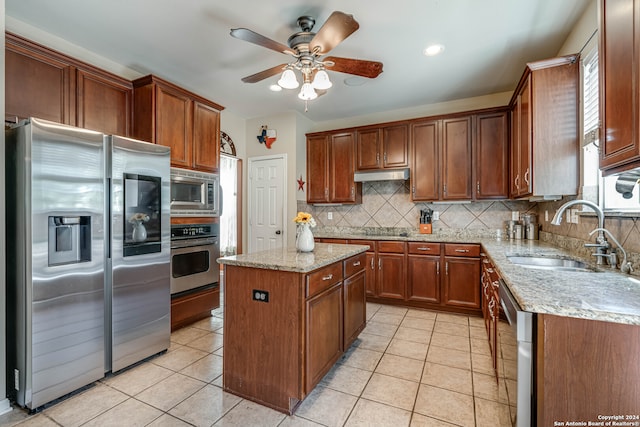 kitchen with decorative backsplash, light tile patterned flooring, stainless steel appliances, a center island, and sink