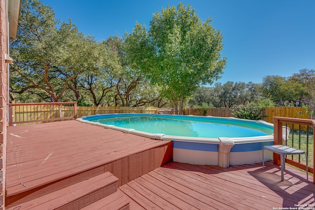 view of swimming pool featuring a deck