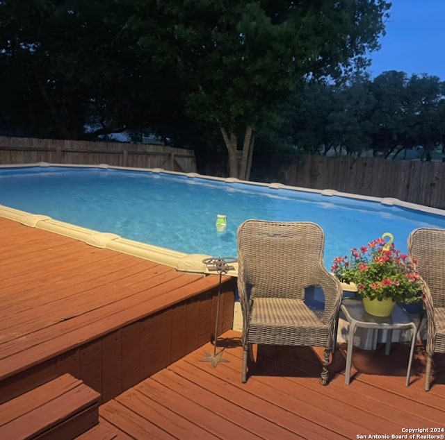 view of swimming pool featuring a deck