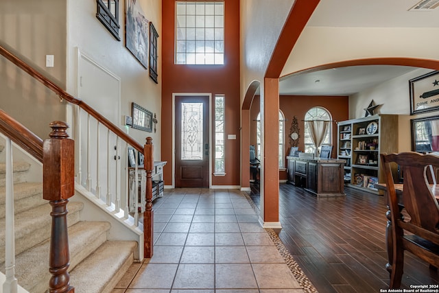 foyer entrance with a high ceiling and hardwood / wood-style flooring