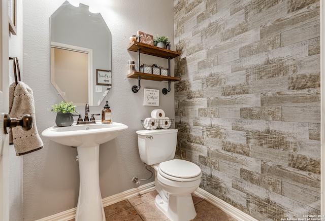 bathroom with tile patterned flooring and toilet