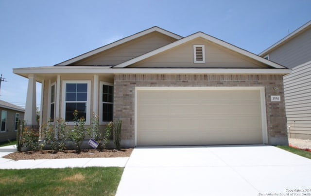 view of front of house featuring concrete driveway, brick siding, and an attached garage