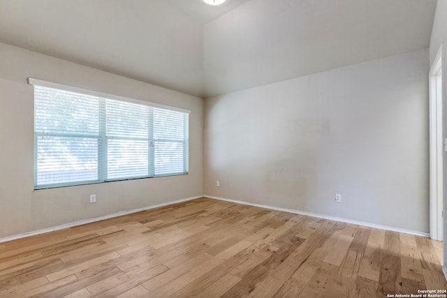 empty room with light wood-style floors and baseboards