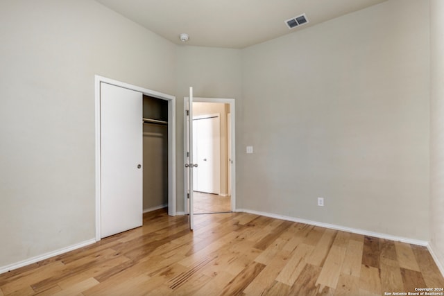 unfurnished bedroom with light wood-style floors, baseboards, and visible vents