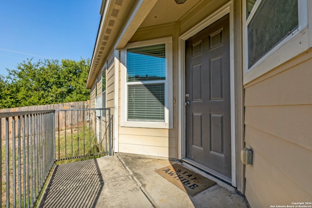 entrance to property featuring fence