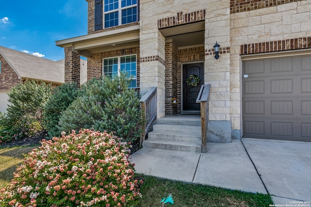 doorway to property with a garage