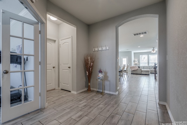 corridor with light hardwood / wood-style flooring