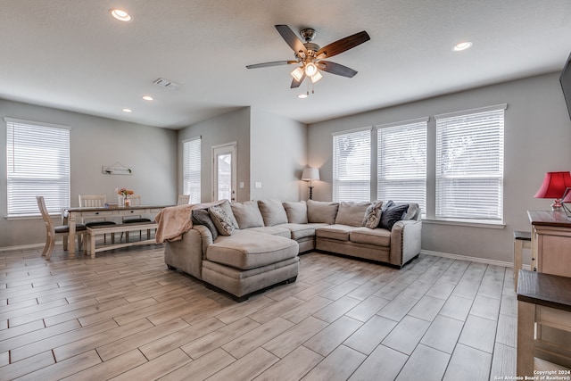 living room featuring ceiling fan and light hardwood / wood-style flooring