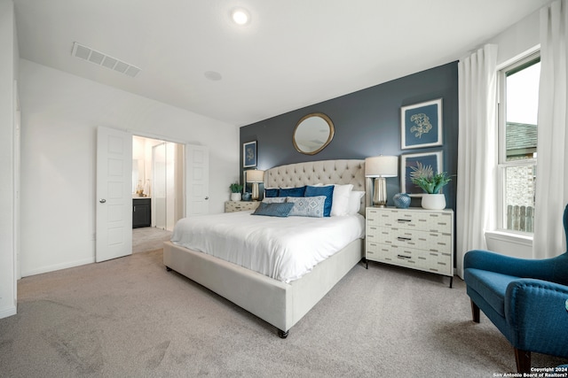 carpeted bedroom featuring multiple windows