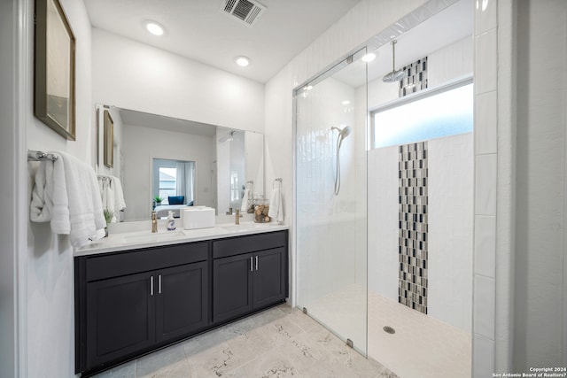 bathroom featuring vanity and tiled shower