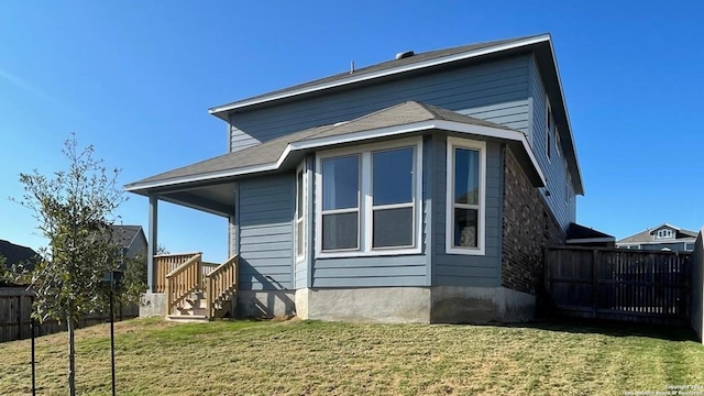 rear view of house with a lawn