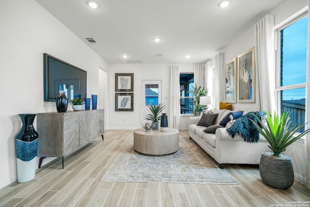 living room with a fireplace and light hardwood / wood-style floors