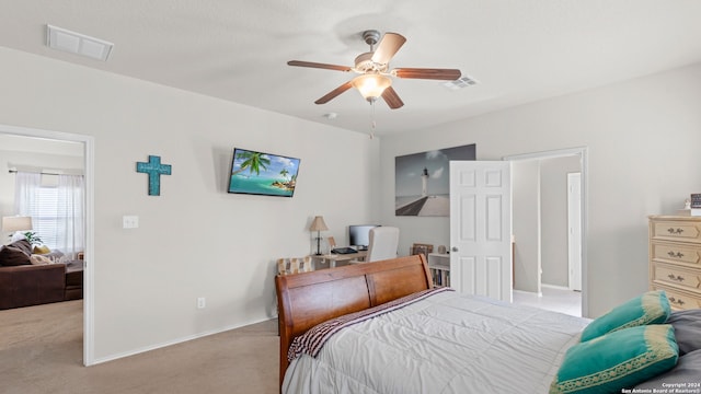 bedroom with ceiling fan and light carpet