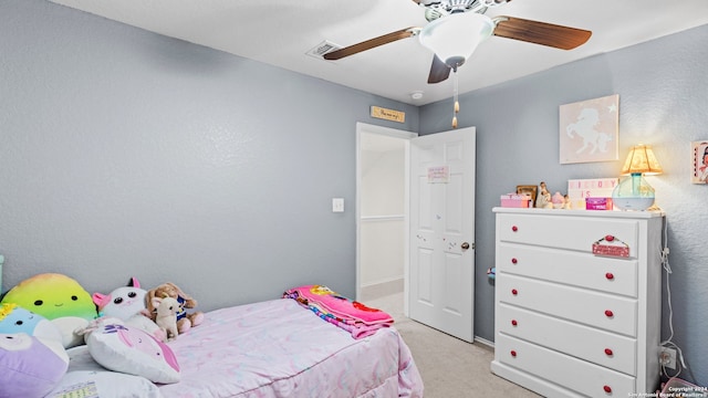 bedroom with ceiling fan and light carpet