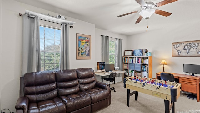 interior space featuring ceiling fan and light colored carpet