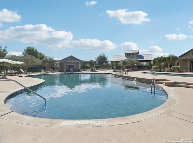 view of swimming pool with a patio