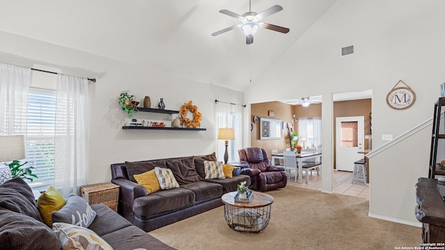 carpeted living room featuring ceiling fan and high vaulted ceiling