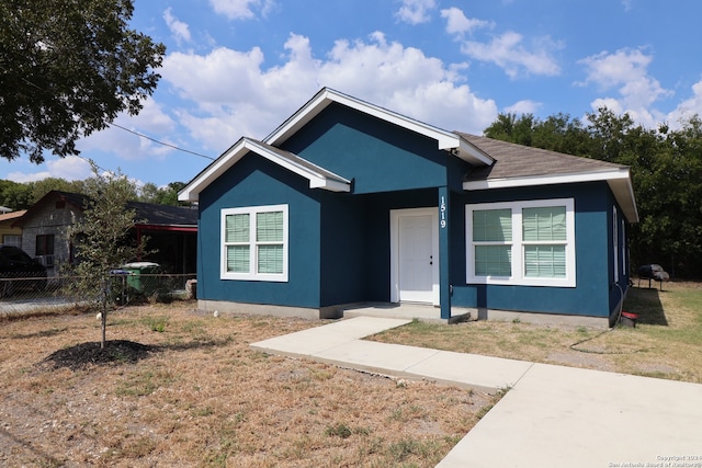 bungalow-style house with a front lawn