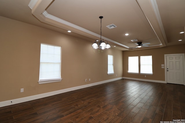 empty room with ceiling fan with notable chandelier, ornamental molding, and dark wood-type flooring