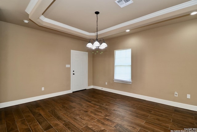unfurnished room featuring ornamental molding, visible vents, dark wood-type flooring, and a raised ceiling