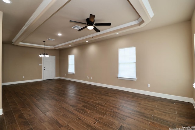 spare room featuring dark wood finished floors, recessed lighting, ceiling fan with notable chandelier, and a raised ceiling
