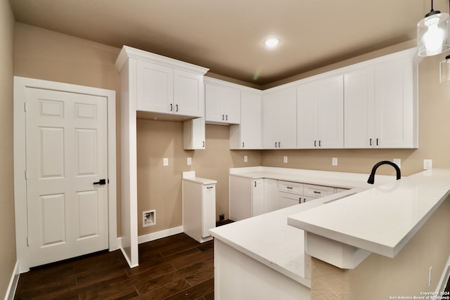 kitchen with hanging light fixtures, dark wood-type flooring, and white cabinets