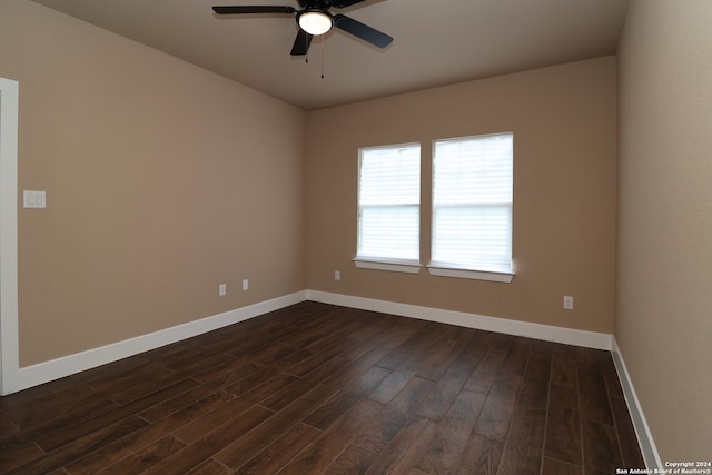 empty room featuring ceiling fan and dark hardwood / wood-style flooring