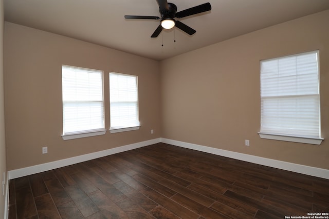 spare room featuring dark hardwood / wood-style floors and ceiling fan