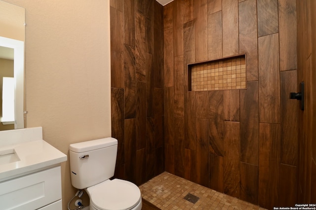 bathroom featuring vanity, a shower, and toilet