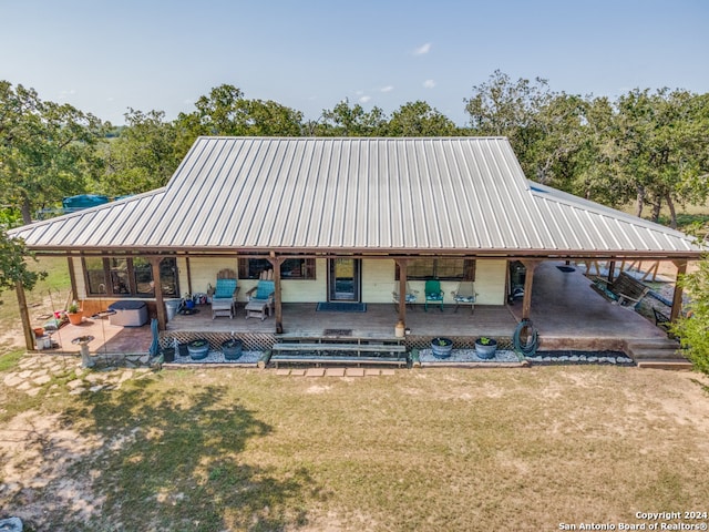 rear view of house with a lawn, an outdoor hangout area, and a patio area