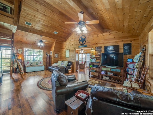 living room with ceiling fan, vaulted ceiling with beams, wood walls, hardwood / wood-style flooring, and wooden ceiling