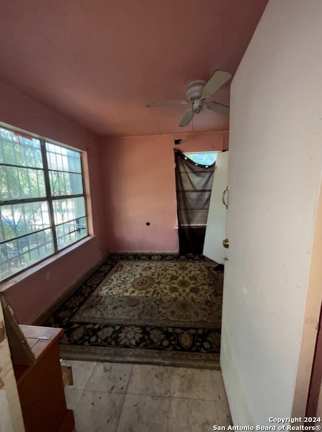 interior space featuring a ceiling fan
