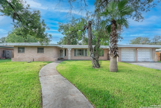 single story home with a front yard and a garage