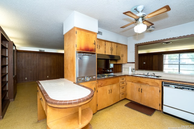 kitchen featuring appliances with stainless steel finishes, tile counters, a textured ceiling, and ceiling fan