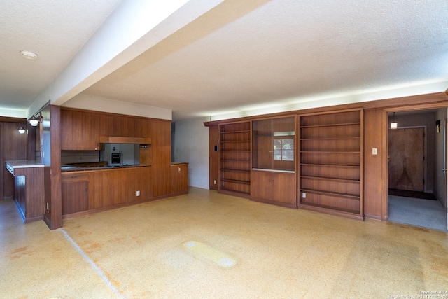 unfurnished living room with a textured ceiling